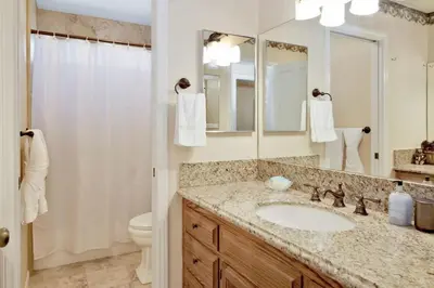 a bathroom with a sink and a toilet and a mirror at Cove Lakefront Chalet #2098 by Big Bear Vacations in Big Bear Lake