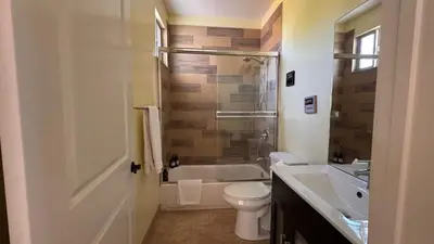 a bathroom with a tub and a toilet and a sink at LA Dream Gem - Beautiful Home with Spa in Los Angeles