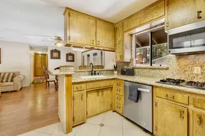 a kitchen with wooden cabinets and a sink at Crestwood Summit #2119 by Big Bear Vacations in Big Bear Lake