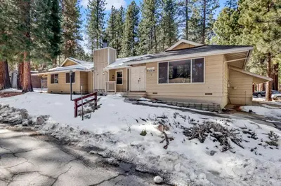 a home in the woods with snow on the ground at Crestwood Summit #2119 by Big Bear Vacations in Big Bear Lake