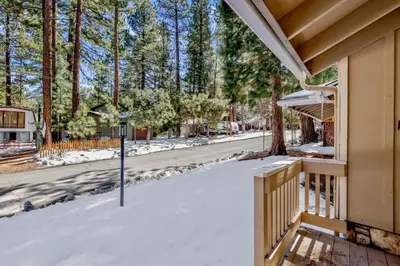 a snow covered porch of a house with a street at Crestwood Summit #2119 by Big Bear Vacations in Big Bear Lake
