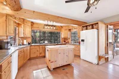 a kitchen with wooden cabinets and a white refrigerator at The Alps Lodge #2142 by Big Bear Vacations in Big Bear Lake