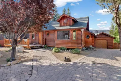a wooden cabin with a patio in front of it at The Alps Lodge #2142 by Big Bear Vacations in Big Bear Lake