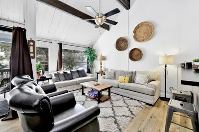 a living room with couches and a ceiling fan at Switzerland Slopes #2125 by Big Bear Vacations in Big Bear Lake