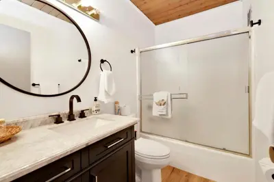 a bathroom with a sink and a shower with a mirror at Switzerland Slopes #2125 by Big Bear Vacations in Big Bear Lake
