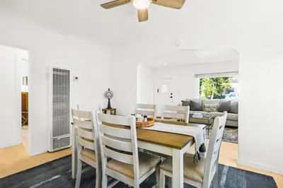 a dining room and living room with a table and chairs at Mid-Town Escape in Ventura