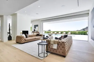 a living room with two couches and a large window at Vista Modern in Los Angeles