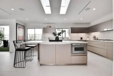 a kitchen with a island with chairs and a counter top at Vista Modern in Los Angeles