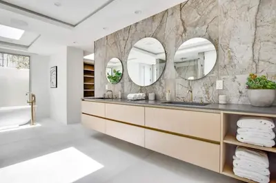 a bathroom with two sinks and two mirrors at Vista Modern in Los Angeles