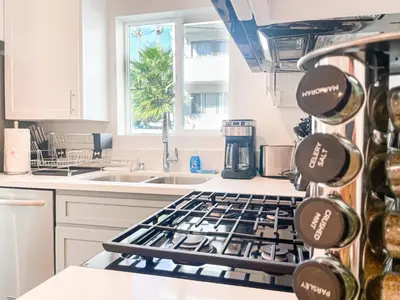 a kitchen with a stove top oven next to a sink at Cozy Habitat in Los Angeles