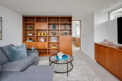 a living room with a couch and a glass table at Vue Modern in Los Angeles