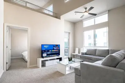 a living room with a couch and a flat screen tv at Luxury Residence Loft 3 Beds with Pool and Gym in Los Angeles