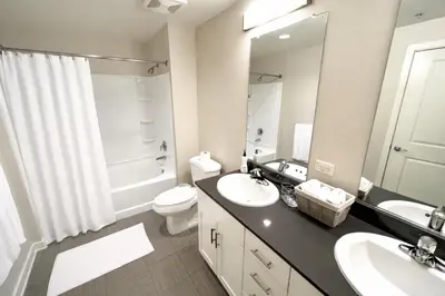 a bathroom with a sink and a toilet and a mirror at Luxury Residence Loft 3 Beds with Pool and Gym in Los Angeles