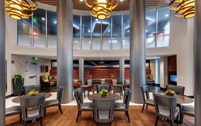 a dining room with tables and chairs in a building at Luxury Residence Loft 3 Beds with Pool and Gym in Los Angeles