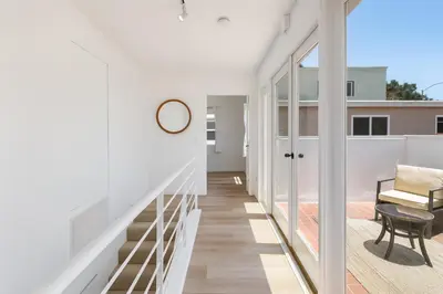 a hallway of a house with white walls and wooden floors at Exclusive 2BD 3BA with Balcony in Los Angeles
