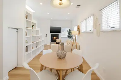 a dining room with a table and white chairs at Exclusive 2BD 3BA with Balcony in Los Angeles