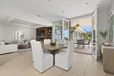 a dining room and living room with a table and chairs at Trousdale Grand in Los Angeles