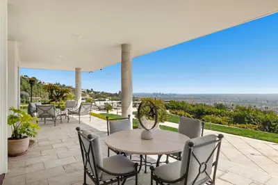 a table and chairs on a patio with a view at Trousdale Grand in Los Angeles