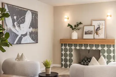 a living room with a fireplace and two chairs at @ Marbella Lane - Vibrant & Chic Designer Home in Fullerton