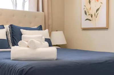 a bedroom with a bed with towels on it at @ Marbella Lane - Vibrant & Chic Designer Home in Fullerton