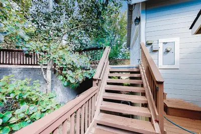a wooden staircase leading to a house with a door at Deer Mountain in Lake Arrowhead