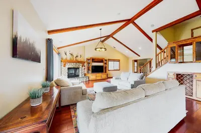 a living room with a couch and a fireplace at Deer Mountain in Lake Arrowhead