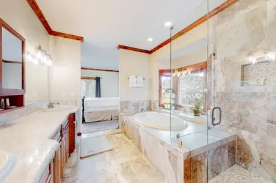 a bathroom with two sinks and a tub and a shower at Deer Mountain in Lake Arrowhead