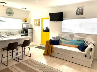 a living room with a couch and a kitchen at King Garden Suite - 10 mins to Beach and LAX in Gardena
