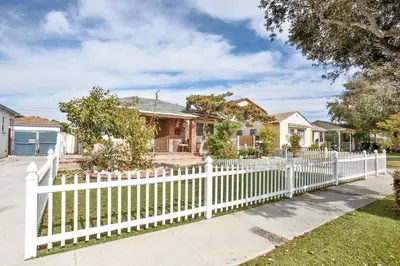 a white picket fence in front of a house at King Garden Suite - 10 mins to Beach and LAX in Gardena