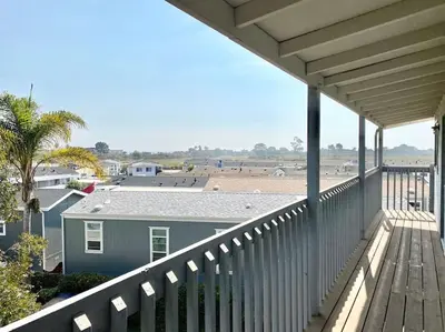 a balcony of a house with a view of the beach at Modern & Cozy Gem ~ Walk to the Beach ~ Queen Beds in Carpinteria
