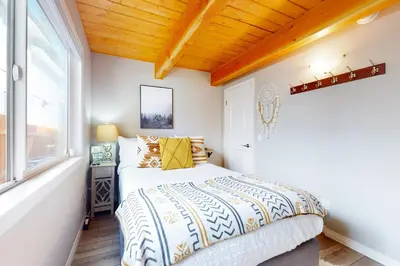 a bedroom with a bed and a window at Hemlock Haven in Lake Arrowhead
