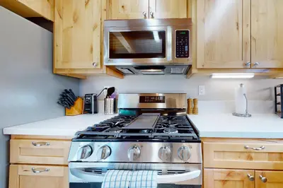 a kitchen with a stove and a microwave at Hemlock Haven in Lake Arrowhead