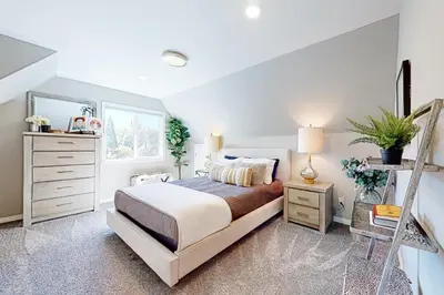 a bedroom with a bed and a dresser and a mirror at Hemlock Haven in Lake Arrowhead