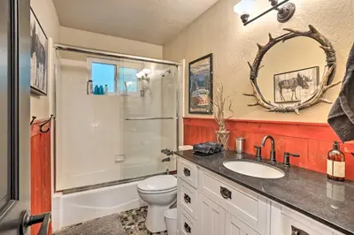 a bathroom with a sink and a shower and a toilet at Lovely Lake Arrowhead Cabin with Furnished Deck in Lake Arrowhead