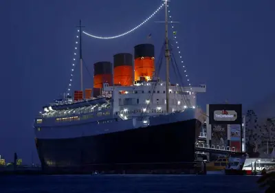 a cruise ship docked in the water at night at Beautiful Guesthouse, Sleeps 4 - Kitchen, Private Laundry, AC, Parking, 65' TV, Close to Stores, Restaurants & Beach in Long Beach