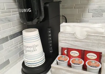 a stack of paper towels and a coffee maker at Beautiful Guesthouse, Sleeps 4 - Kitchen, Private Laundry, AC, Parking, 65' TV, Close to Stores, Restaurants & Beach in Long Beach
