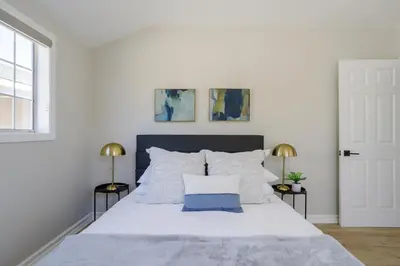 a bedroom with a large white bed with two lamps at New 5 bed w/hot tub close to Universal sleeps 12 in Los Angeles