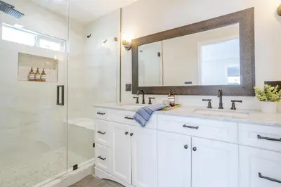 a white bathroom with two sinks and a shower at New 5 bed w/hot tub close to Universal sleeps 12 in Los Angeles