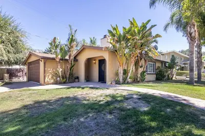 a house with palm trees in front of a driveway at Woodland Hills 3 bedroom w/ pool and spa in Los Angeles