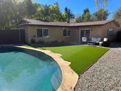 a backyard with a swimming pool and a house at Woodland Hills 3 bedroom w/ pool and spa in Los Angeles