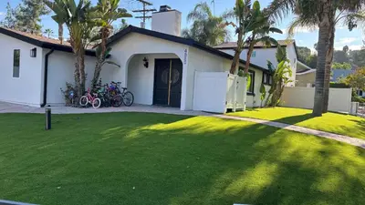 a house with a green lawn in front of it at Woodland Hills 3 bedroom w/ pool and spa in Los Angeles