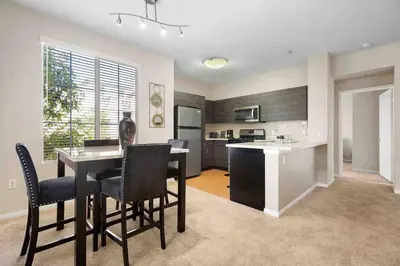 a kitchen and living room with a table and chairs at COZY 2BR/2BA ! 5MINtoDisney ! AngelStadium!HondaCenter in Anaheim