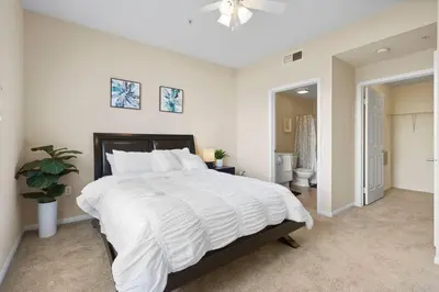 a large white bedroom with a large white bed at COZY 2BR/2BA ! 5MINtoDisney ! AngelStadium!HondaCenter in Anaheim
