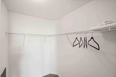 a white room with a clothes line with hangers at COZY 2BR/2BA ! 5MINtoDisney ! AngelStadium!HondaCenter in Anaheim