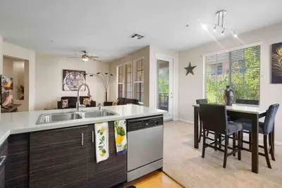 a kitchen with a sink and a table with chairs at COZY 2BR/2BA ! 5MINtoDisney ! AngelStadium!HondaCenter in Anaheim
