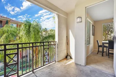 a balcony with a view of a table and chairs at COZY 2BR/2BA ! 5MINtoDisney ! AngelStadium!HondaCenter in Anaheim