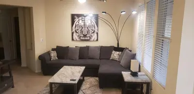 a living room with a couch and a picture of a zebra at COZY 2BR/2BA ! 5MINtoDisney ! AngelStadium!HondaCenter in Anaheim