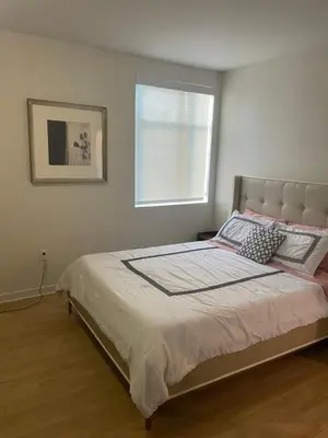 a bedroom with a large bed with a window at Super-Cute 2/2 apartment in Santa Monica with free parking in Los Angeles