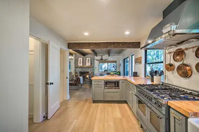 a kitchen with a stove and a counter top at Pet-Friendly Retreat with Game Room and Fire Pit! in Lake Arrowhead