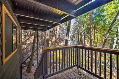 a view from the balcony of a cabin in the woods at Pet-Friendly Retreat with Game Room and Fire Pit! in Lake Arrowhead